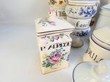 many different types of ceramic containers on the table