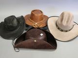 several hats are lined up on a white surface