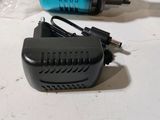 an image of a blow dryer and a charger on a table
