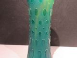 a green vase that is sitting on a table