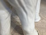 a white elephant that is standing on the floor