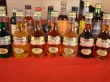 many bottles of alcohol sitting on a red table