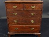an antique wooden chest of drawers with brass handles