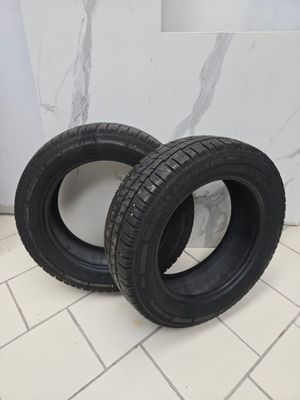 two tires are sitting on a tile floor in a bathroom