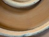 a close up view of a brown vase with a white rim