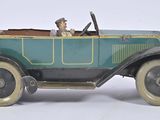 a toy car with a man sitting in the driver ' s seat