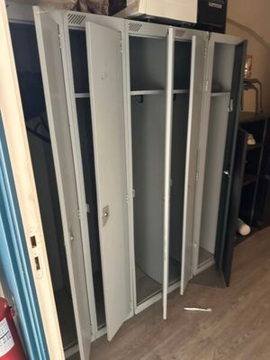 several lockers in a room with a fire extinguisor in the background