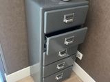 a small refrigerator with a computer on top of it