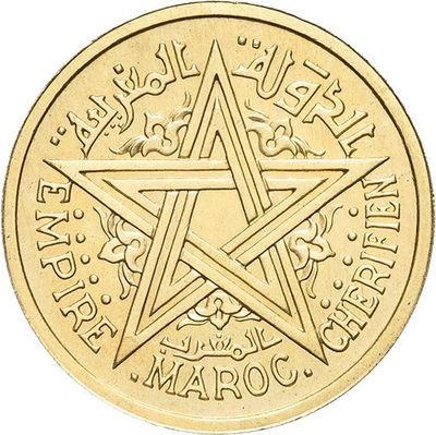 a close up of a gold coin with a star on it