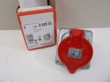 a red fire hydrant sitting on a table next to a box