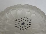 a glass cake plate with a decorative design on it