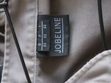 a label on the back of a jacket on a hanger