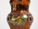 a vase that is sitting on a white surface