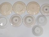 many plates that are sitting on a white table