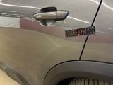 a close up of a car door handle with a sticker on it