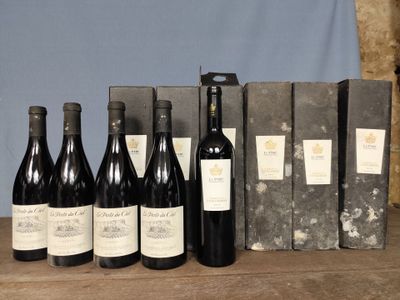 several bottles of wine are lined up on a wooden table