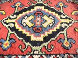 an image of a close up of a colorful rug on a wooden floor