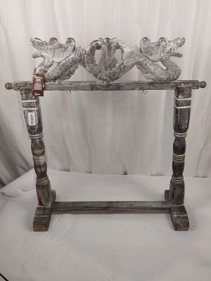 pair of silver plated birds on a wooden stand on a white background