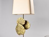 a close up of a lamp on a table with a lamp shade on it