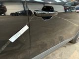 a close up of a car door handle with a sticker on it