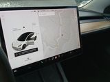 a car dashboard with a computer on it and a map on the screen