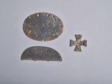two pieces of metal that have been placed on a white surface