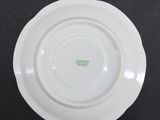 a close up of a white plate on a black surface