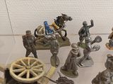 many figurines of soldiers on display in a glass case