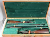 two shotguns in a case on a table