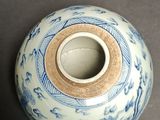 a blue and white vase sitting on a table