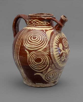 brown and white vase with spiral designs on it against a gray background