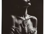 a black and white photo of a woman with her hands on her chest