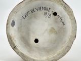 an image of a white porcelain vase with a black inscription on it