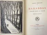 an open book with a drawing of a person walking down a path in the woods