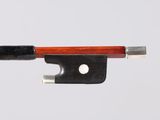 a violin bow with a wooden handle on a white surface