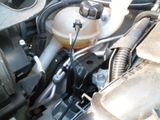 a close up of a car ' s engine with a fuel tank