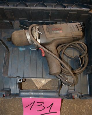 a tool in a plastic box with a pink sticker on it