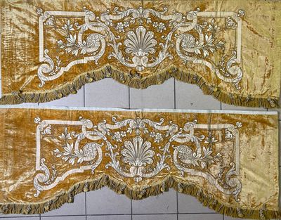 two pieces of gold velvet with white and gold designs on them