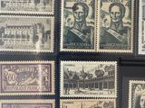 a lot of stamps that are on display on the wall
