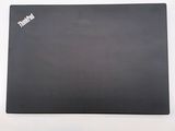 the back of a black laptop computer sitting on top of a white table