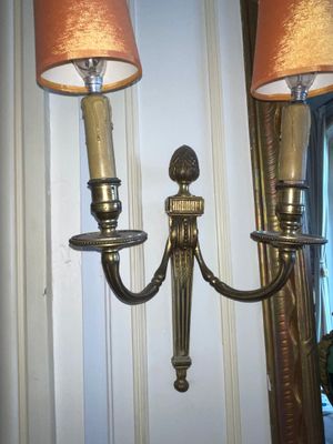 two lamps that are on the wall next to each other