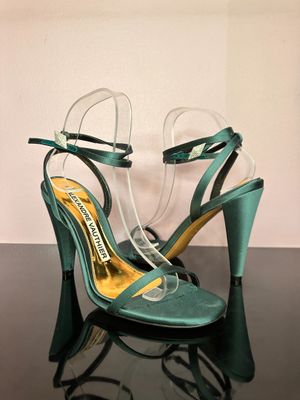 pair of green high heeled shoes on a black table