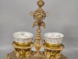 two cups on a stand with a clock on it