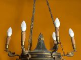 a chandelier with five lights hanging from it ' s ceiling