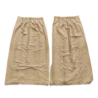 two pieces of brown paper on a white background with a pair of brown pants