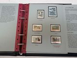 an open book with stamps on it on a table
