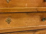a wooden dresser with four drawers on top of it