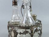 a silver plate with a glass decanter on it