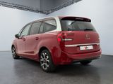 the rear of a red citrole parked in a garage