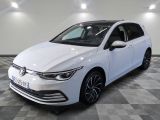the white volkswagen golf is parked in a room with a checkered floor